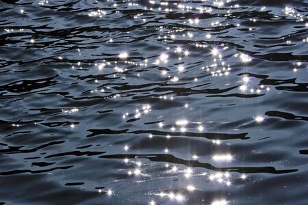 bright glittering light on a rippled water surfaceの写真素材