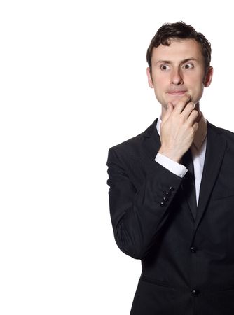 uncertain businessman in a black suit isolated over white with a lot of copy-spyceの写真素材