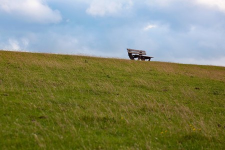 a bench in the sunset on a dike at the northsea, Germanyの写真素材