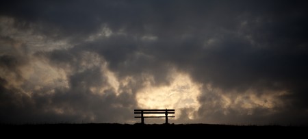 a bench in the sunset on a dike at the northsea, Germanyの写真素材