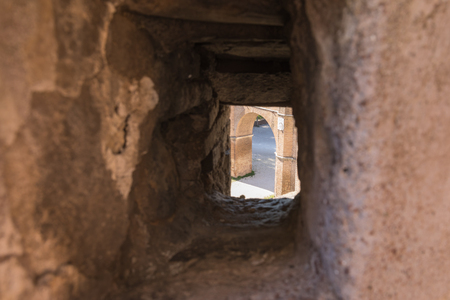 View of the ancient arch through the embrasure in the wall of the fortressのeditorial素材