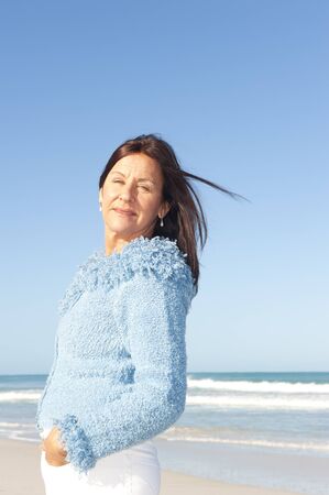 Portrait sexy senior woman leisure at beach, isolated with ocean and blue sky as background and copy space.の写真素材