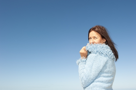Portrait of confident and happy relaxed looking attractive senior woman enjoying active retirement in winter sunの写真素材