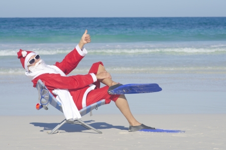 Santa Claus sitting with flippers and snorkel at beachの写真素材