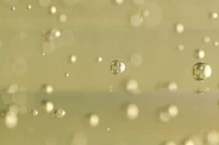 Abstract blurred background with floating drops and soft light reflection 
