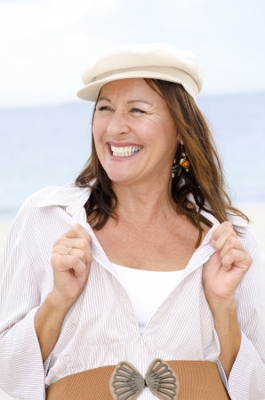 Portrait happy confident attractive mature woman jouful and smiling, isolated outdoor with white bright blurred background.の写真素材