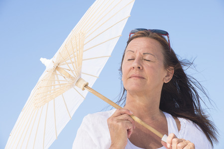 Portrait happy relaxed attractive mature woman with closed eyes at summer sunny day outdoor.の写真素材