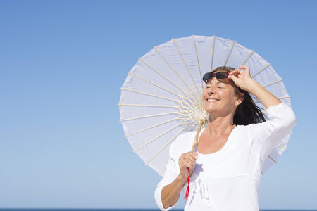 Portrait happy relaxed attractive mature woman summer sunny day outdoor.の写真素材