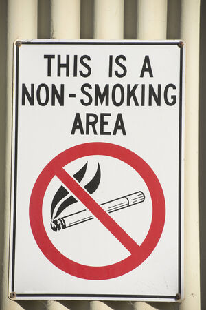 No smoking sign outside wall of building. Warning of health risk.の写真素材