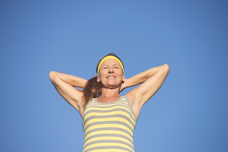 Portrait successful active attractive mature woman in confident pose, sporty, healthy, fit, arms...