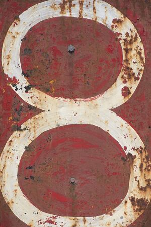 Number Eight writen white on red background on rusty metal sign, copy space.