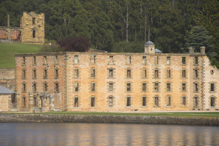 World Heritage Site of former Penal Convict Settlement Port Arthur on Tasmania, Australia, with ruin of prison at water of harbour and other old buildings.のeditorial素材
