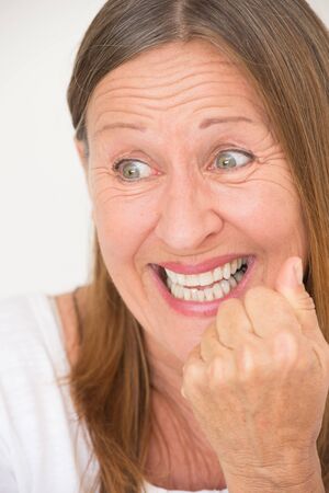 Portrait joyful happy successful attractive mature woman, positive excited, confident smiling, laughing, thumb up, bright background.の写真素材