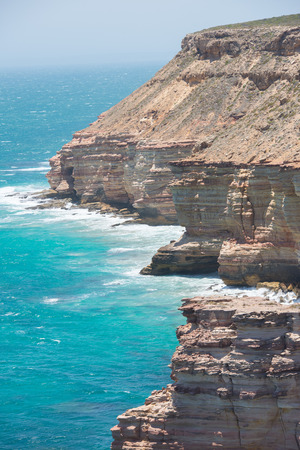 Beautiful Aerial panorama of  rugged rock cliff coast formation of Kalbarri National Park in Western Australia, wild sea of Indian Ocean, blue sky, horizon, copy space.の写真素材