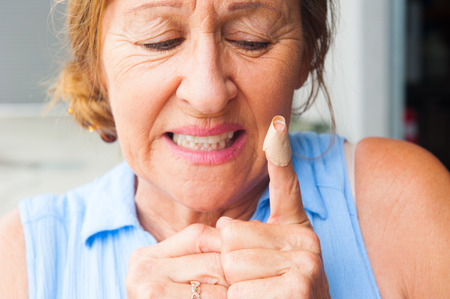Portrait woman with stressed facial expression, in pain, hurt and suffering, close up of plaster on...