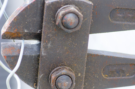 Close up detail of heavy metal bolt clipper bite in fence.