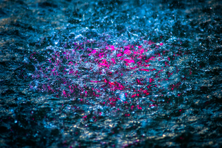 Boiling jets, rain drops, splashes, bubbles and waves of clean water illuminated with violet of...