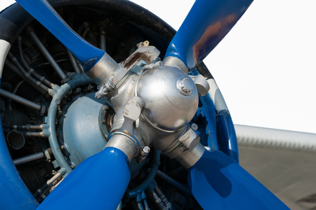 Single-engine aircraft engine and propeller isolated against white background. Blue and white colors.の写真素材