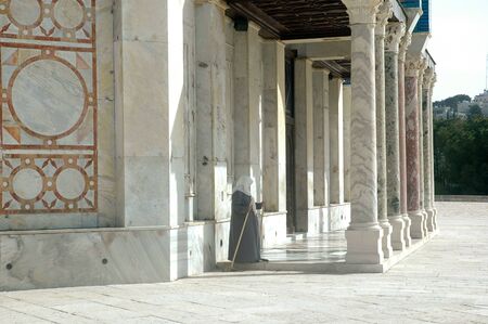 A muslim woman, perhaps a caretaker, pauses momentarily on the Temple Mount, in Jerusalemの写真素材