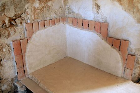 Ruins of a Roman heating system in a room called a caldarium in Masada, Israelの写真素材