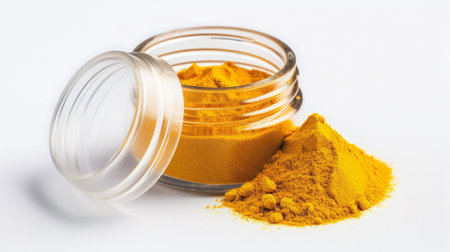 Turmeric powder in a glass jar isolated on white background. Top view.の素材