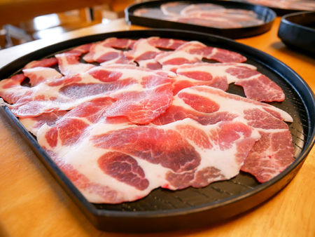 close up of slide pork on black plateの写真素材
