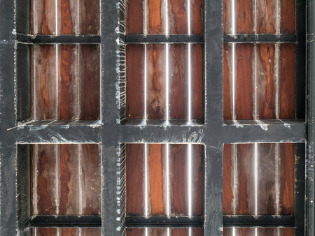 Bottom view of wood floor and black steel box frameの写真素材