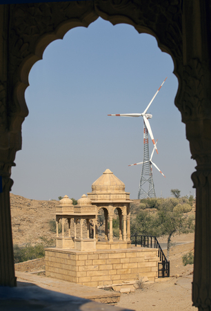Wind power plants in Jaisalmer on a background of Hindu temples in the desert, Indiaの写真素材