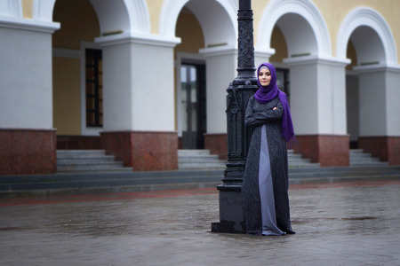 street photo a beautiful Muslim woman in traditional dress on the background of the European building, Tatarstanの写真素材