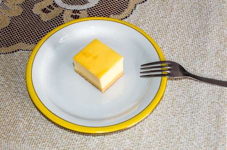 Cheesecake on white plate with fork.の写真素材