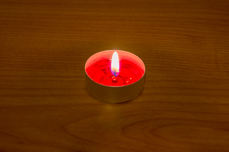 Burning red aromatic candle.の写真素材