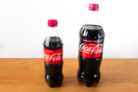 Pruszcz Gdanski, Poland - January 3, 2018: Coca-Cola Cherry and Coca-Cola Cherry Zero in plastic bottles on wooden table.のeditorial素材