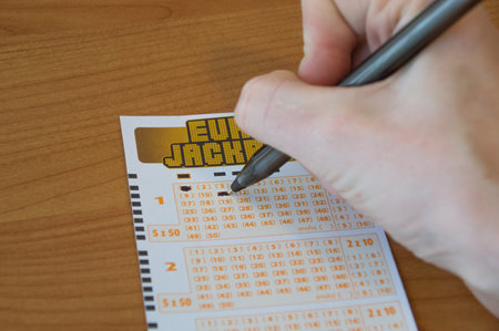 Pruszcz Gdanski, Poland - January 13, 2018: Man hand filling out a Eurojackpot ticket. Eurojackpot is European lottery.のeditorial素材