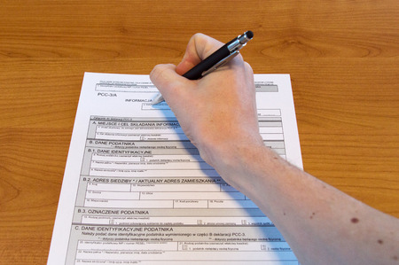 Man hand filling Polish tax form PCC-3 / A.の写真素材