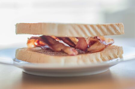 Fried bacon between two crunchy toast.