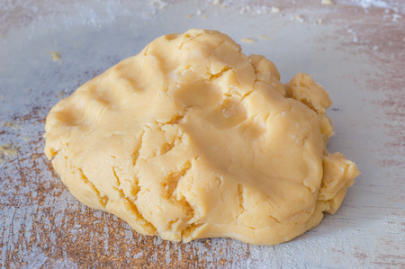 Raw dough for Polish cupcakes cake on wooden desk.の写真素材