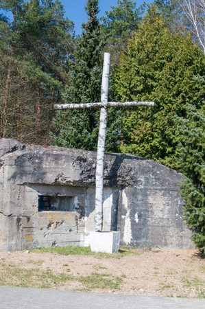 A wooden cross next to the bunker at the commemoration of the battle of Mlawa, which took place during the Second World War.の写真素材
