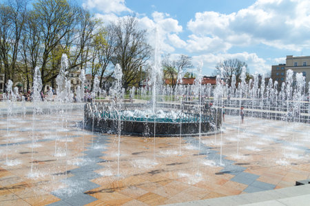 Lublin, Poland - April 14, 2018: Fountain located at the Lithuanian Square with unidentified people in the city center of Lublin.のeditorial素材