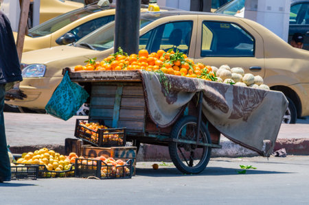 Marrakesh, Morocco - June 3, 2018: A trolley with orange stands on the street.のeditorial素材