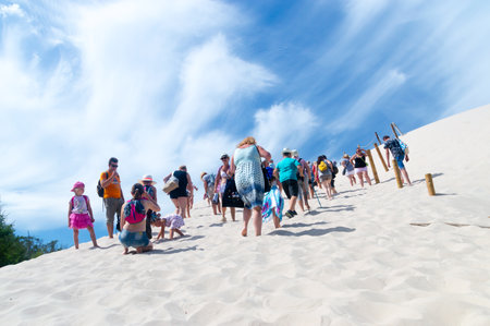Leba, Poland - August 7, 2018: People walking on sand dunes at Slowinski National Park.のeditorial素材