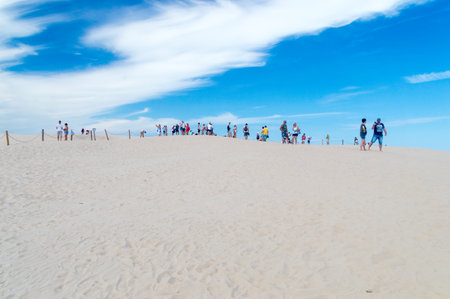 Leba, Poland - August 7, 2018: Tourist on sand Lacka dune at Slowinski National Park.のeditorial素材