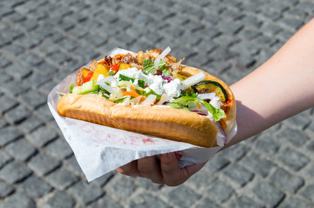 Kebab of Mustafa's Gemuese Kebab in a woman's hand.の写真素材