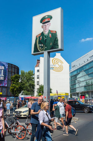 Berlin, Germany - August 16, 2018: Poster with Russian soldier at Checkpoint Charlie.のeditorial素材