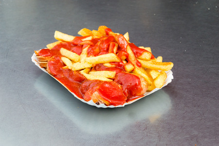 Currywurst with french fries  and ketchup.の写真素材