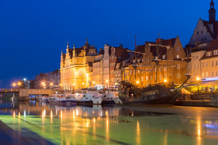Gdansk, Poland - August 28, 2018: Motlawa river bank with ships in Old Town of Gdansk at dusk.のeditorial素材