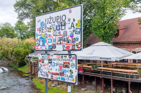 Vilnius, Lithuania - September 28, 2018: Stickers on sign of bridge of Uzupis.