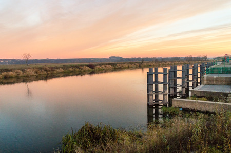 Orange sunset over Narew river in Lomza, Poland.の写真素材