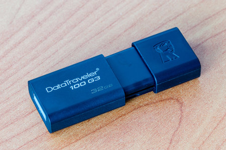 Pruszcz Gdanski, Poland - December 15, 2018: Pendrive Kingston Data Traveler 100 G3 32GB on wooden table.のeditorial素材