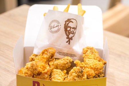 Pruszcz Gdanski, Poland - December 28, 2018: Chicken hot wings with french fries from KFC. Food from KFC (Kentucky Fried Chicken) fast food.のeditorial素材