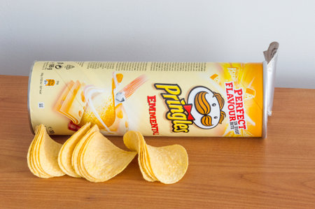 Pruszcz Gdanski, Poland - January 4, 2019: Open tube of Pringles chips with Pingles chips on the table.のeditorial素材